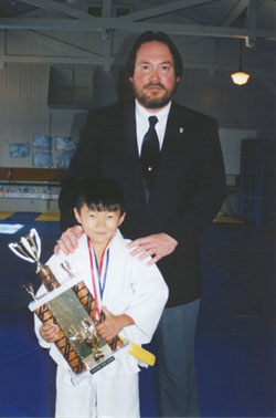 Instructor Alain Wilkinson and student Daniel Kodama after winning a trophy in Dec 2002